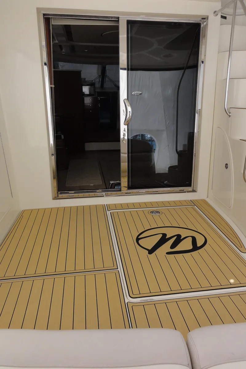 Slide: The Image of 2009 Meridian 441 Sedan yacht deck with sliding glass door and logo. - 28