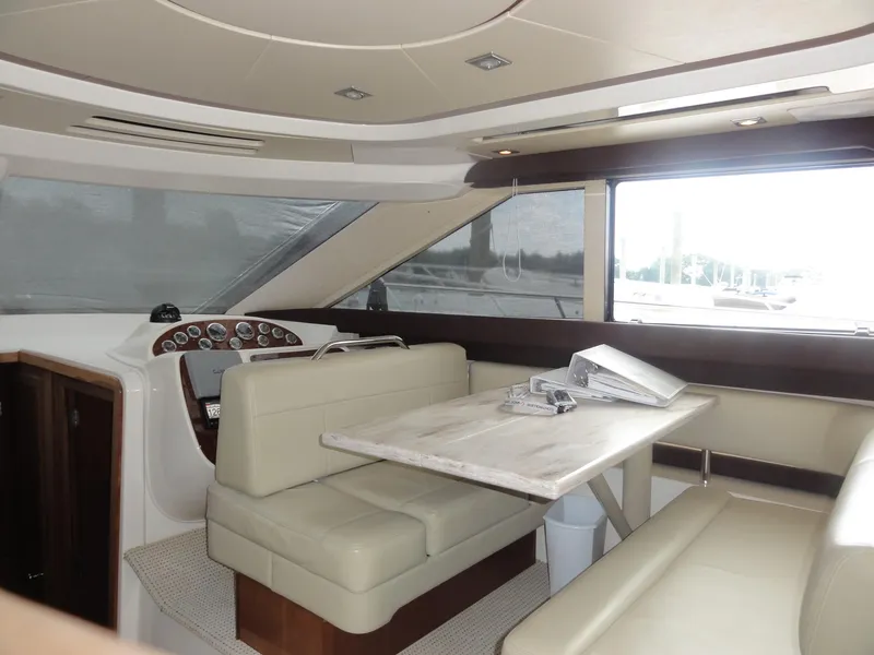 Slide: The Image of Interior of 2009 Meridian 441 Sedan yacht with beige seating and wooden table. - 33