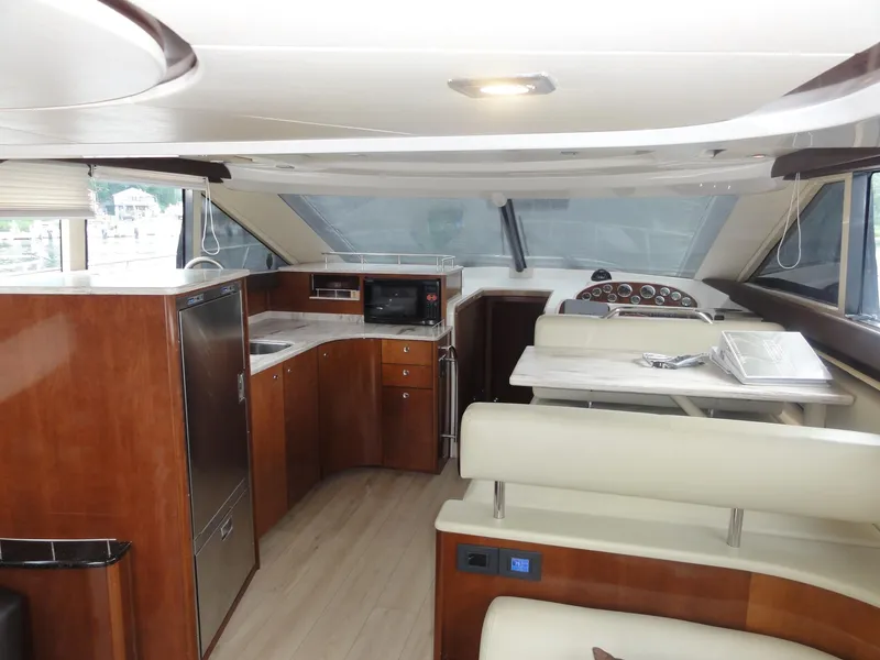 Slide: The Image of Luxurious interior of a 2009 Meridian 441 Sedan yacht with modern kitchen and seating area. - 36