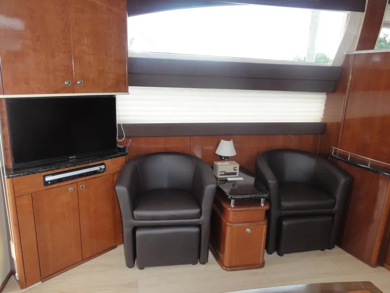 Slide: The Image of Interior of 2009 Meridian 441 Sedan with leather chairs, TV, and wooden cabinetry. - 43