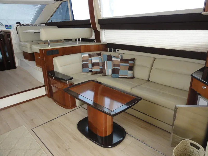 Slide: The Image of Luxurious interior of 2009 Meridian 441 Sedan yacht with beige seating and wooden table. - 45