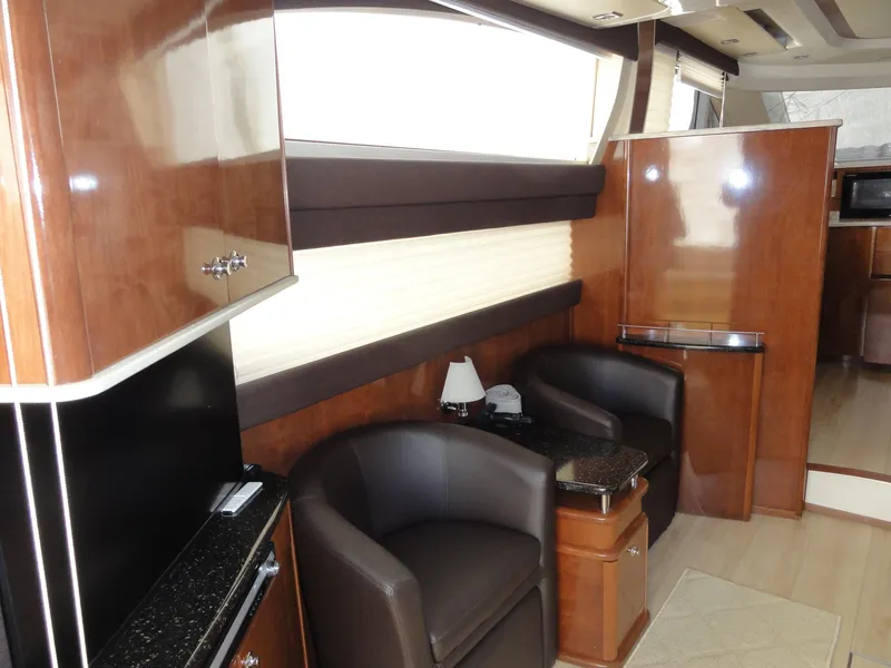 Slide: The Image of Luxurious interior of a 2009 Meridian 441 Sedan yacht with elegant wood finishes and seating. - 46