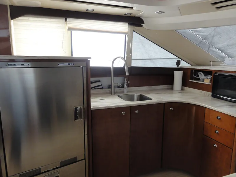 Slide: The Image of 2009 Meridian 441 Sedan yacht kitchen with stainless steel appliances and modern cabinetry. - 51