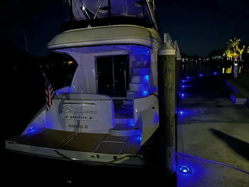 Slide: The Image of Meridian 441 Sedan Yacht, 2009, at night with blue lighting. - 7