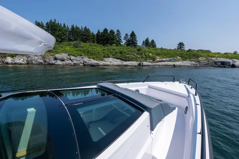 Slide: The Image of Axopar 37 Aft Cabin 2026 on calm waters with US flag. - 19