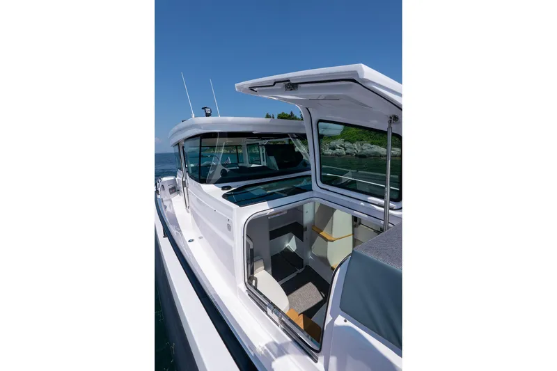 Slide: The Image of Side view of Axopar 37 Aft Cabin 2026 on the sea. - 25