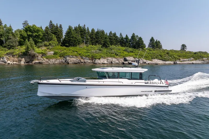 Slide: The Image of 2026 Axopar 37 Aft Cabin cruising on open water. - 8