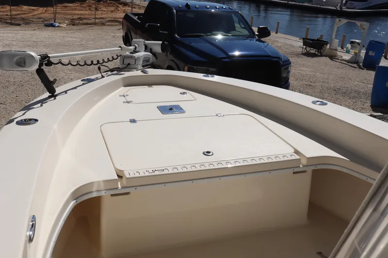 Slide: The Image of 2013 Young Boats 24 model at dockside with a black truck in the background. - 10