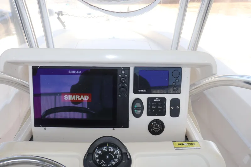 Slide: The Image of 2013 Young Boats 24 dashboard with Simrad and Yamaha electronics. - 19