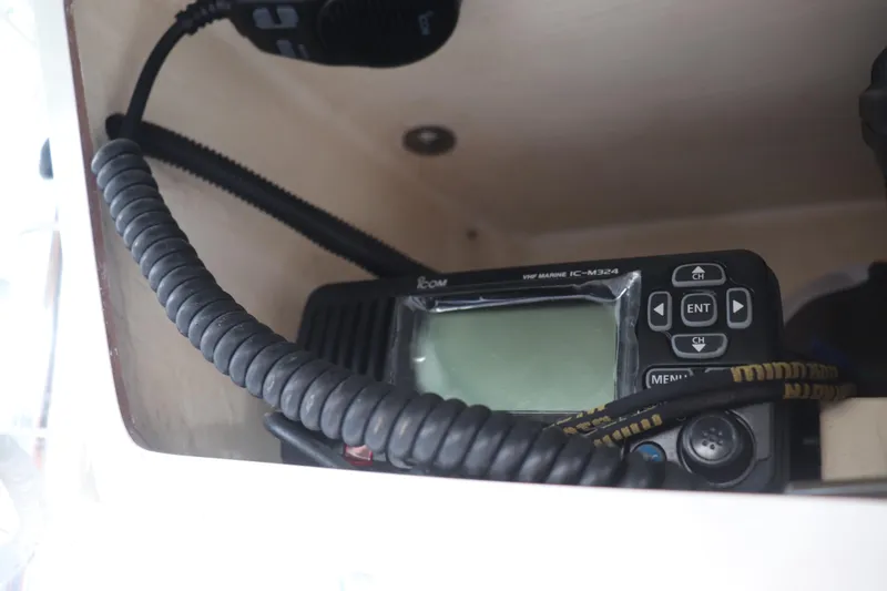 Slide: The Image of VHF marine radio on 2013 Young Boats 24, coiled cable visible. - 28