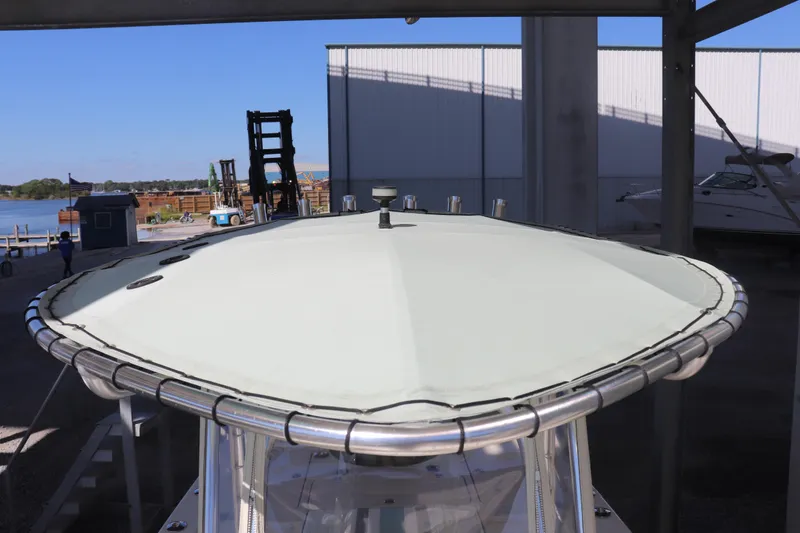 Slide: The Image of 2013 Young Boats 24 with T-top, docked near waterfront facility. - 29