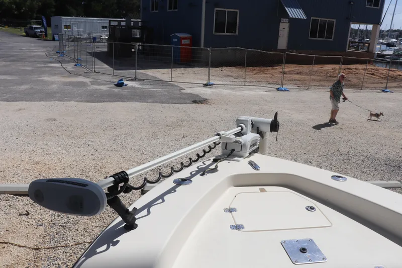 Slide: The Image of 2013 Young Boats 24 on gravel, with person walking dog in background. - 34