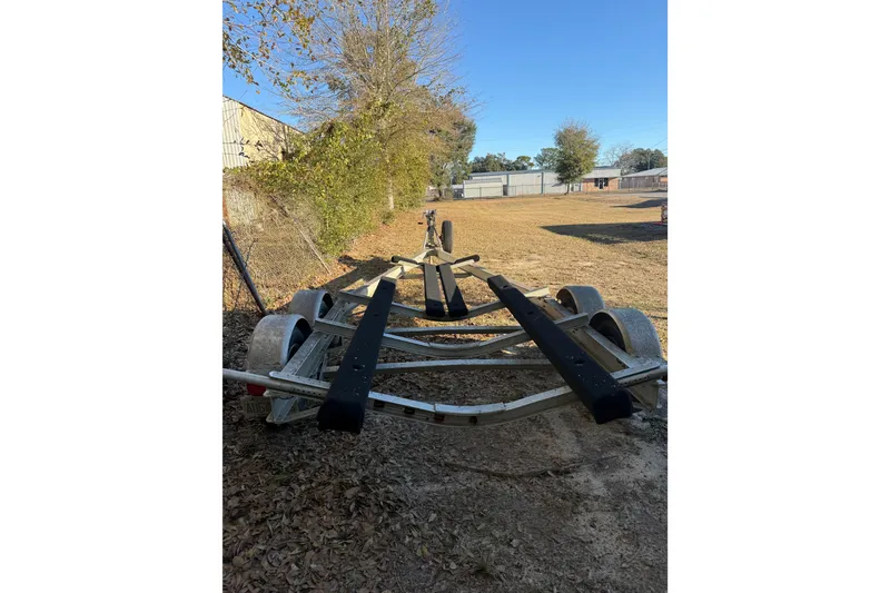Slide: The Image of Trailer for 2013 Young Boats 24, parked outdoors on a sunny day. - 37