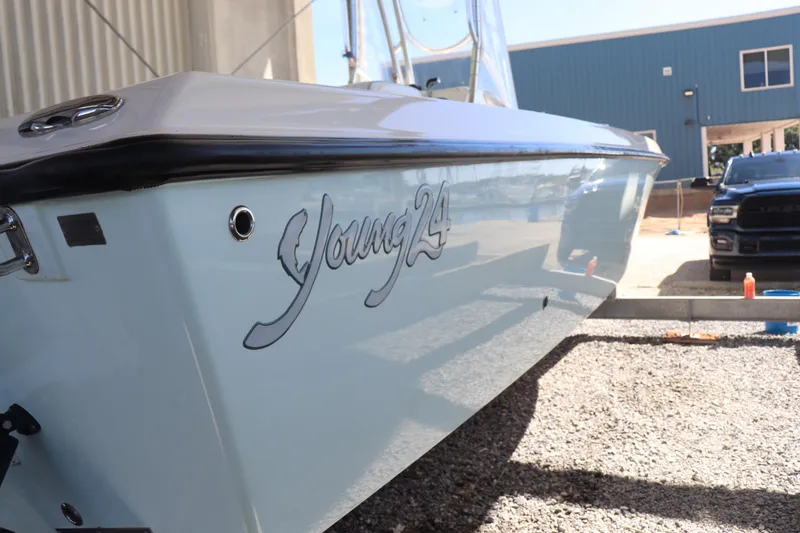 Slide: The Image of 2013 Young Boats 24 model on trailer, side view with logo visible. - 5