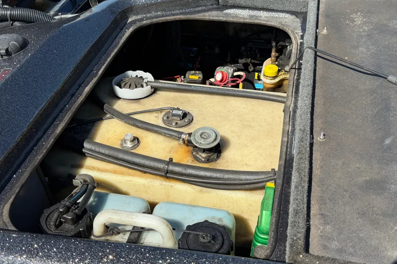 Slide: The Image of 2017 Bass Cat Eyra boat engine compartment with visible fuel tank and components. - 15