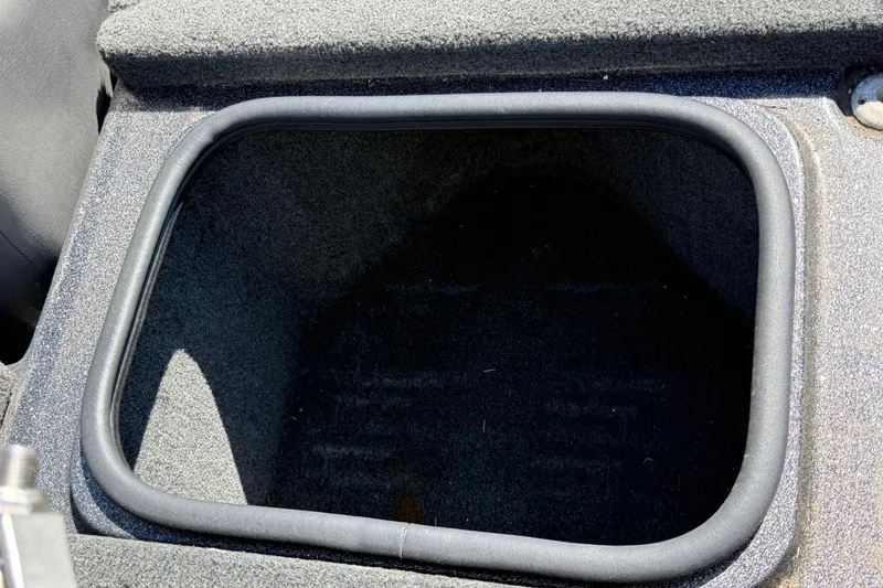 Slide: The Image of 2017 Bass Cat Eyra boat storage compartment, open and empty, with a black interior. - 18