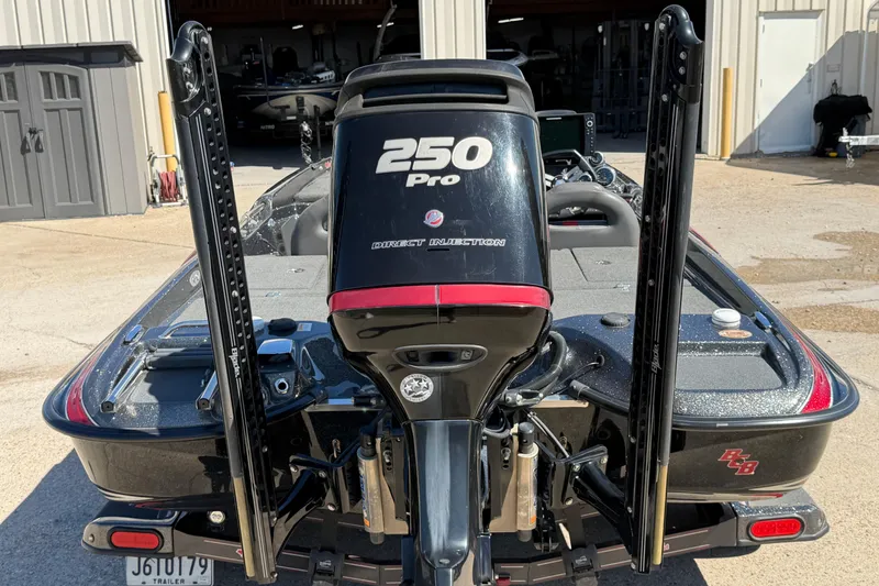 Slide: The Image of 2017 Bass Cat Eyra boat with 250 Pro engine, parked outside a garage. - 5