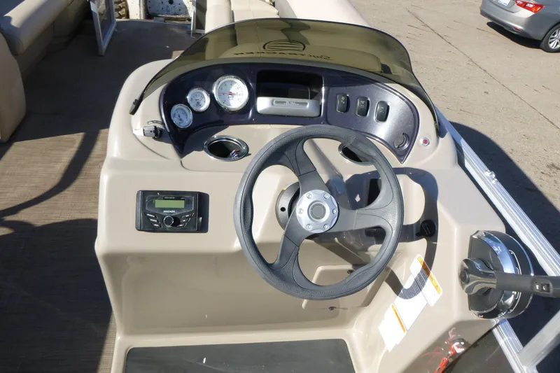 Slide: The Image of 2022 Sun Tracker Party Barge 18 DLX steering console with gauges and controls. - 11