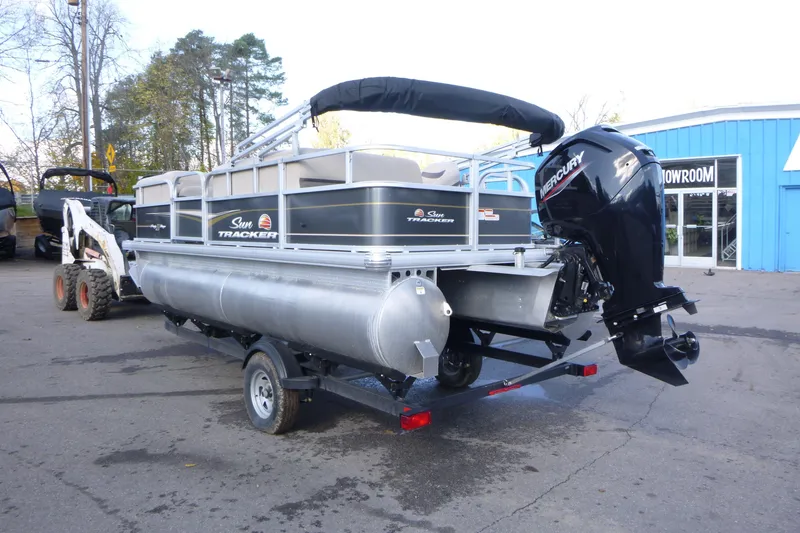 Slide: The Image of 2022 Sun Tracker Party Barge 18 DLX pontoon boat on trailer, parked outdoors. - 3