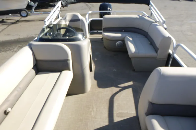 Slide: The Image of 2022 Sun Tracker Party Barge 18 DLX interior with spacious seating and steering console. - 5