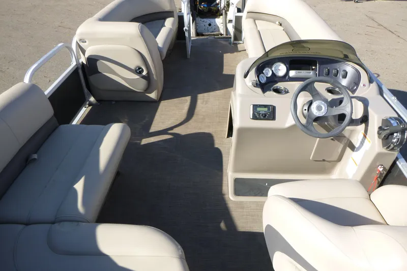 Slide: The Image of 2022 Sun Tracker Party Barge 18 DLX interior with helm and seating area. - 6