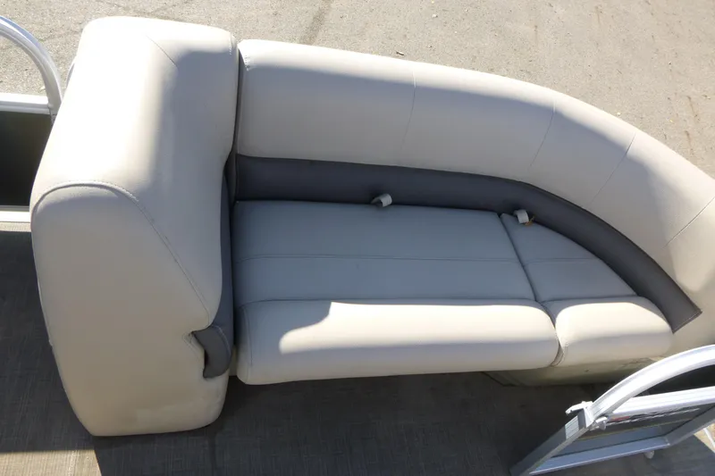 Slide: The Image of 2022 Sun Tracker Party Barge 18 DLX pontoon boat seating, featuring plush, curved upholstery. - 8