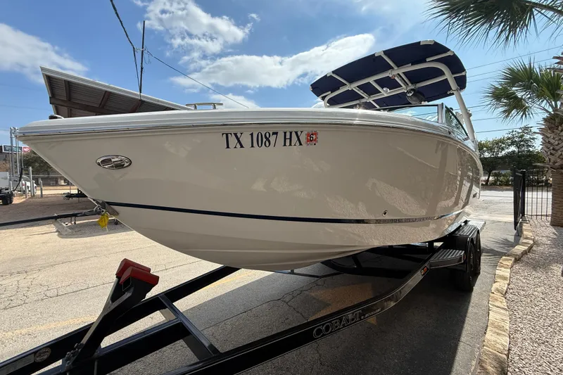 Slide: The Image of 2020 Cobalt R5 Surf boat on trailer, parked outdoors under a sunny sky. - 4