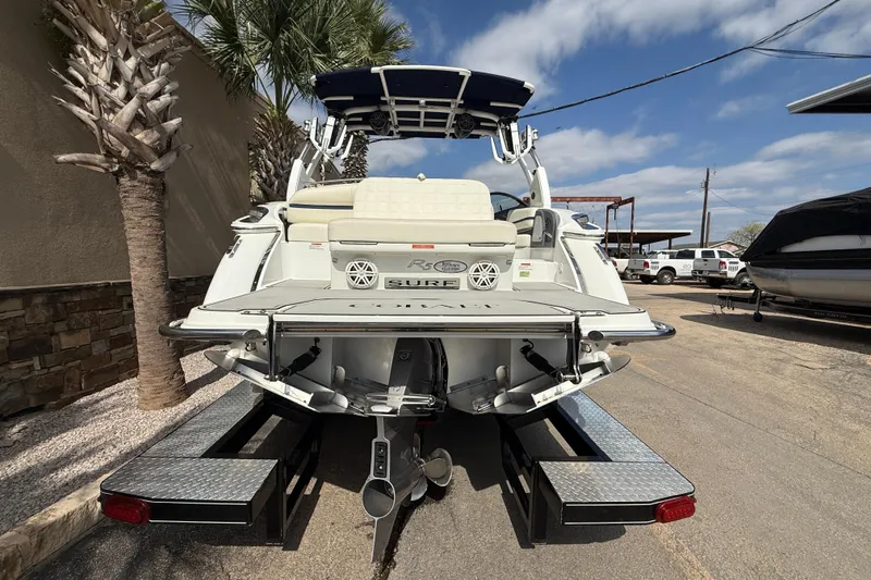 Slide: The Image of 2020 Cobalt R5 Surf boat, rear view, parked outdoors under a blue sky. - 5