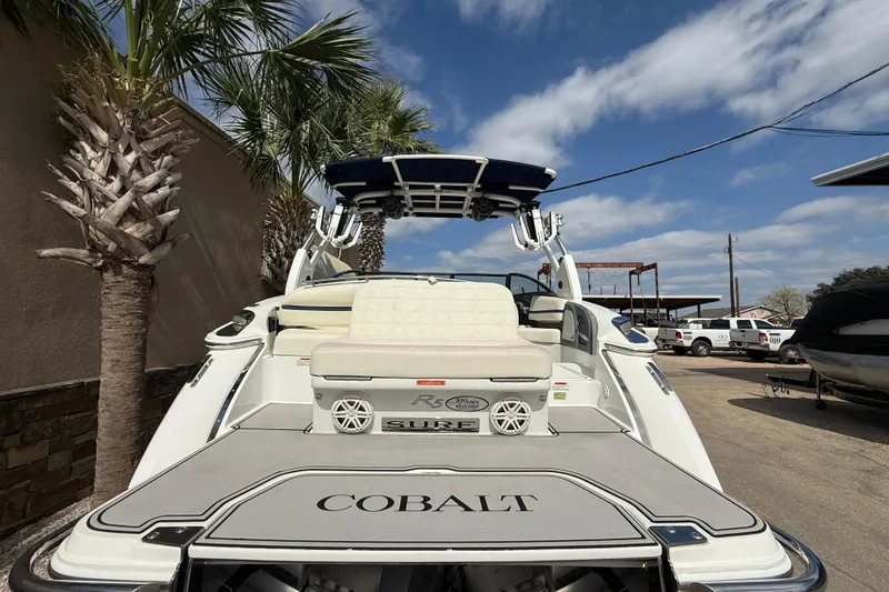 Slide: The Image of 2020 Cobalt R5 Surf boat with palm trees and blue sky background. - 6