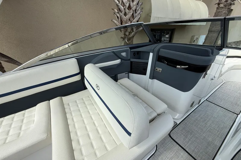 Slide: The Image of 2020 Cobalt R5 Surf boat interior with white and navy seating, sleek design. - 8
