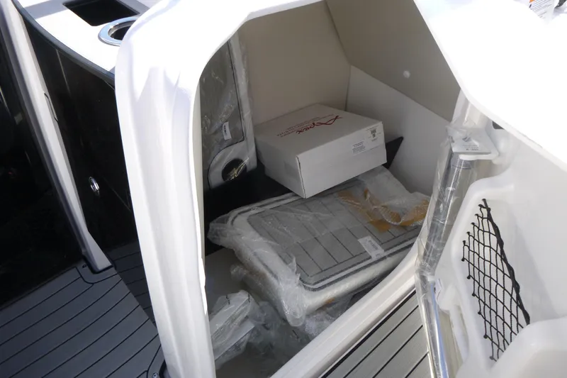 Slide: The Image of Storage compartment of 2026 Yamaha Boats 252SD, featuring organized interior space. - 14