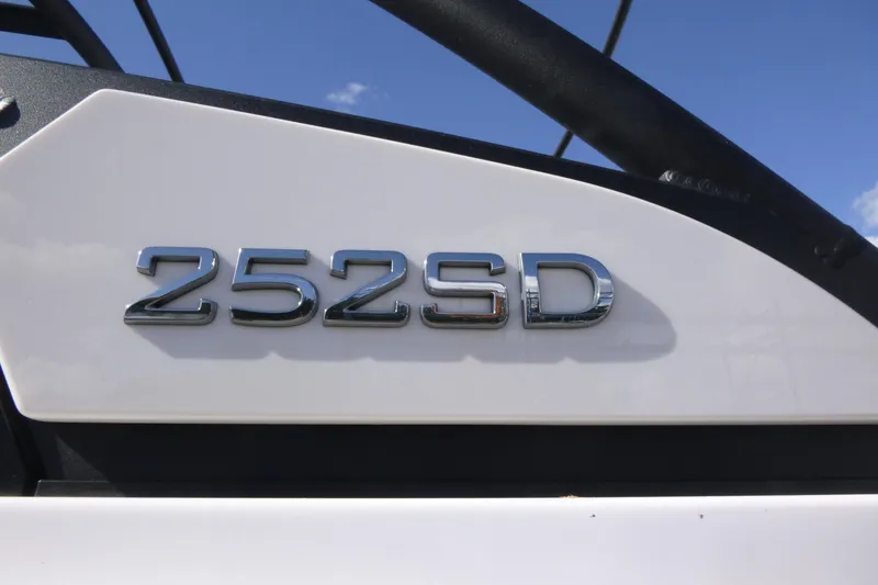 Slide: The Image of 2026 Yamaha Boats 252SD model emblem on white surface under blue sky. - 19