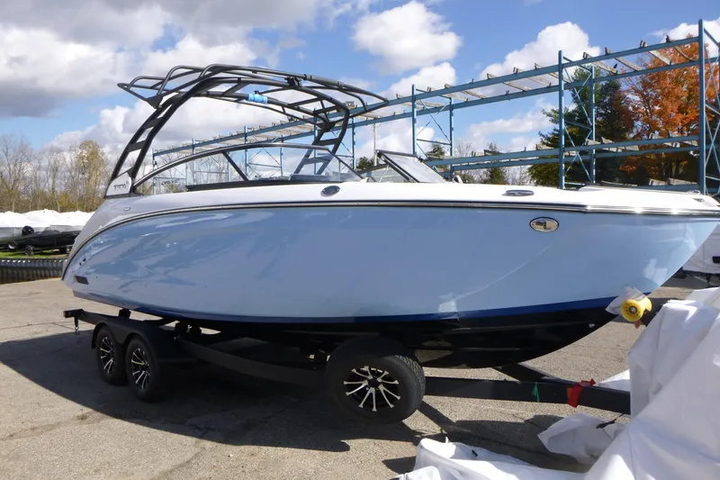 Slide: The Image of 2026 Yamaha Boats 252SD on trailer, sleek design under blue sky. - 2