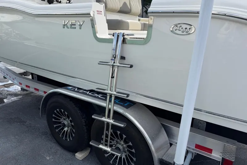 Slide: The Image of 2026 Key West 291 FS boat on trailer with ladder and logo visible. - 10