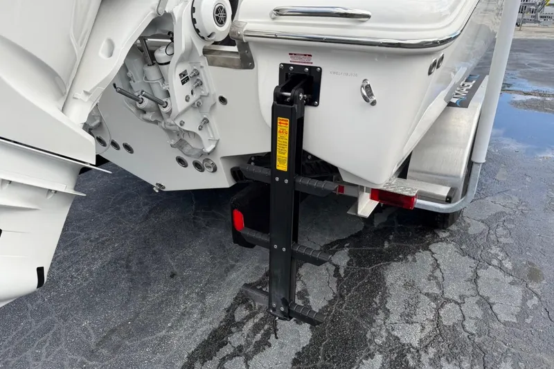 Slide: The Image of 2026 Key West 291 FS boat with a mounted ladder on a trailer. - 13