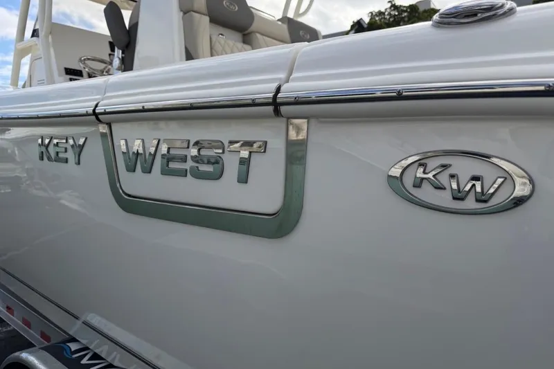 Slide: The Image of 2026 Key West 291 FS boat with KW logo and sleek design. - 15