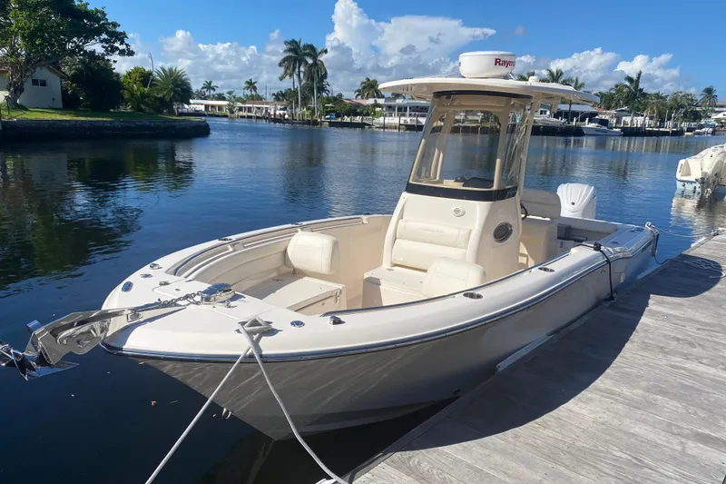 Slide: The Image of 2024 Grady-White Fisherman 236 boat docked by a scenic waterfront. - 0