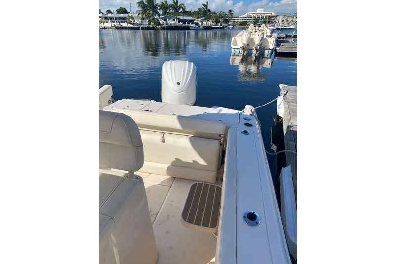 Slide: The Image of 2024 Grady-White Fisherman 236 boat docked at marina, calm water view. - 14