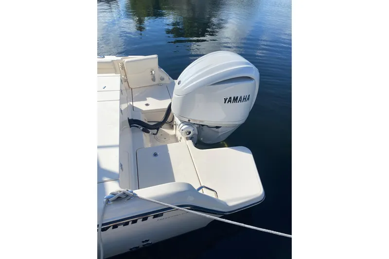 Slide: The Image of 2024 Grady-White Fisherman 236 with Yamaha outboard engine on calm water. - 17