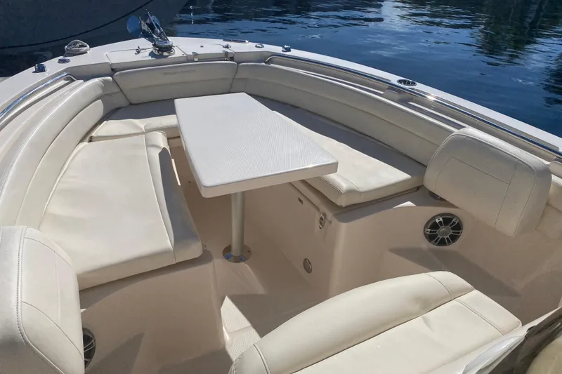 Slide: The Image of 2024 Grady-White Fisherman 236 boat interior with cushioned seating and table. - 3