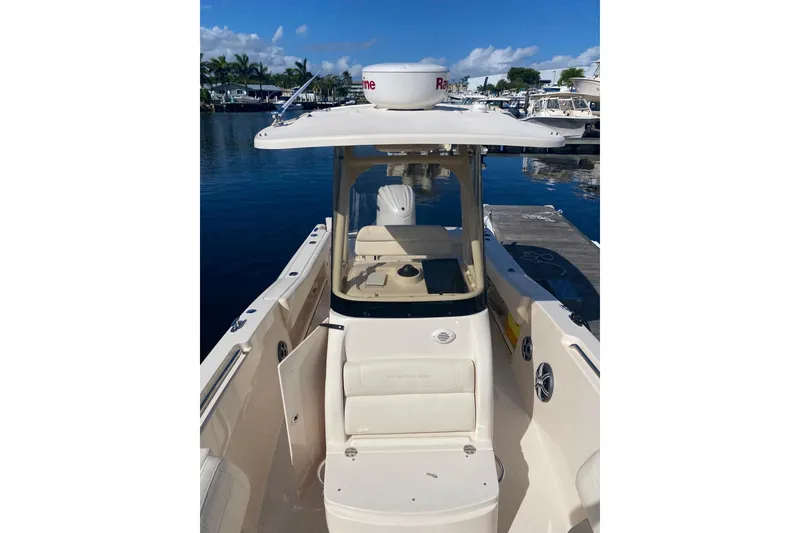 Slide: The Image of 2024 Grady-White Fisherman 236 boat docked, showcasing helm and seating area. - 5