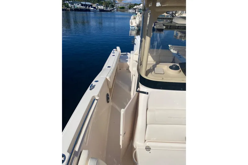 Slide: The Image of 2024 Grady-White Fisherman 236 boat docked, showcasing sleek design and spacious deck. - 6