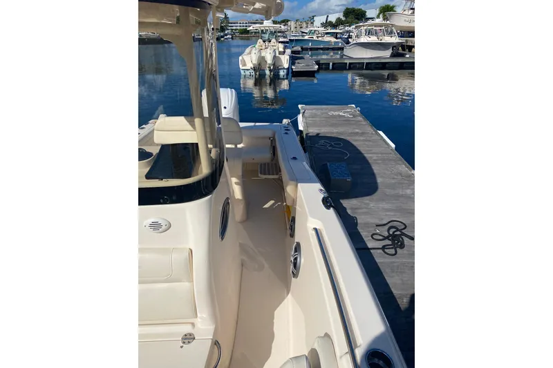 Slide: The Image of 2024 Grady-White Fisherman 236 docked at marina, sunny day, calm waters. - 7