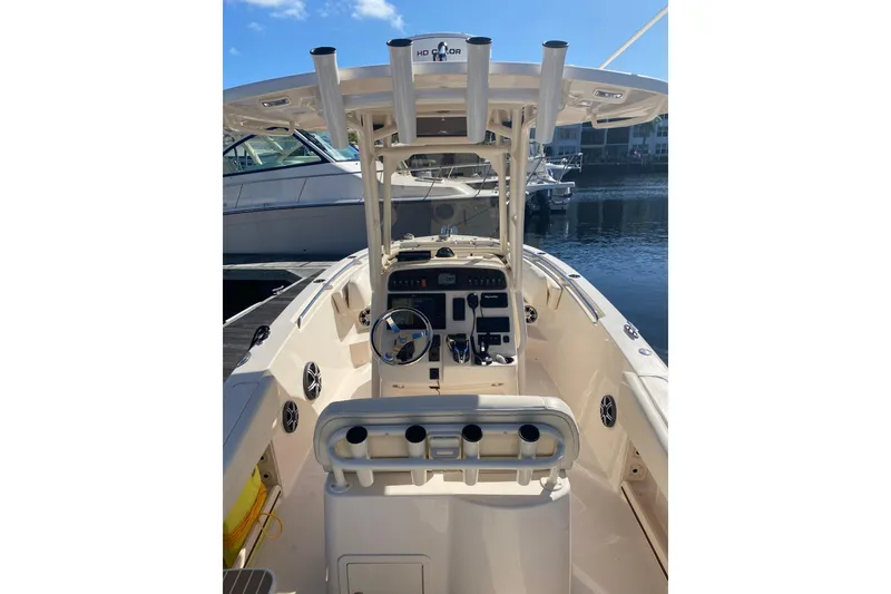Slide: The Image of 2024 Grady-White Fisherman 236 boat interior with steering console and rod holders. - 9