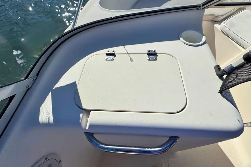 Slide: The Image of 2002 Sea Hunt Escape 200 boat interior with storage compartment and handle. - 12