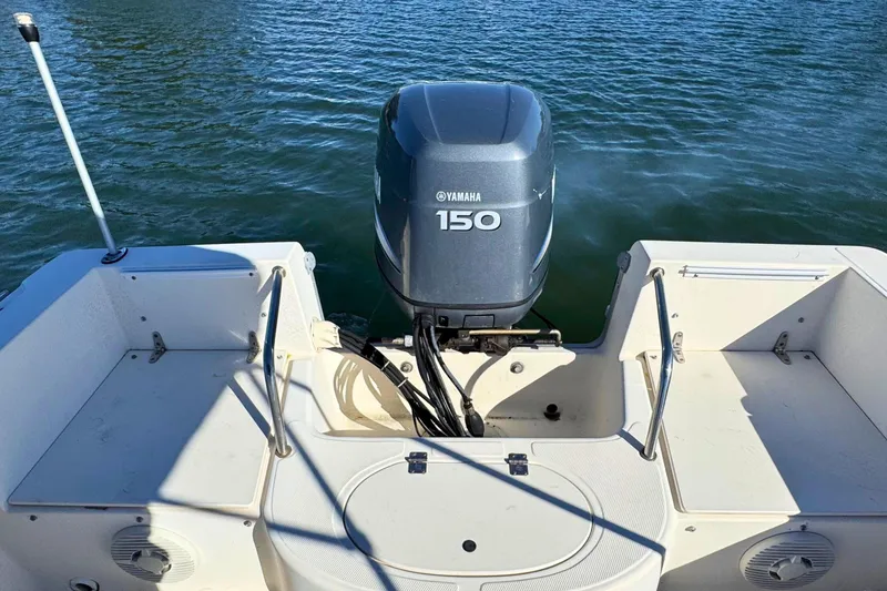 Slide: The Image of 2002 Sea Hunt Escape 200 boat with Yamaha 150 engine on calm water. - 8