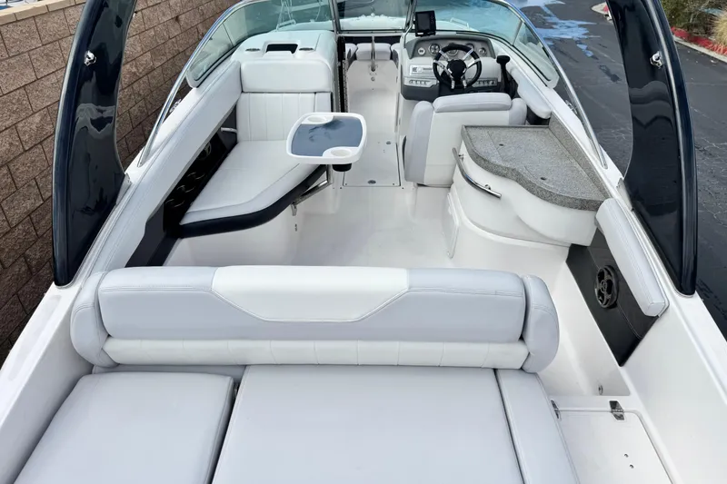 Slide: The Image of 2014 Regal 27 FasDeck boat interior with white seating and modern dashboard. - 12