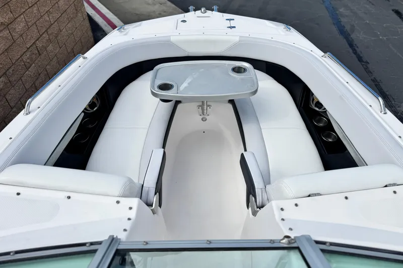 Slide: The Image of 2014 Regal 27 FasDeck boat interior with white seating and a central table. - 15