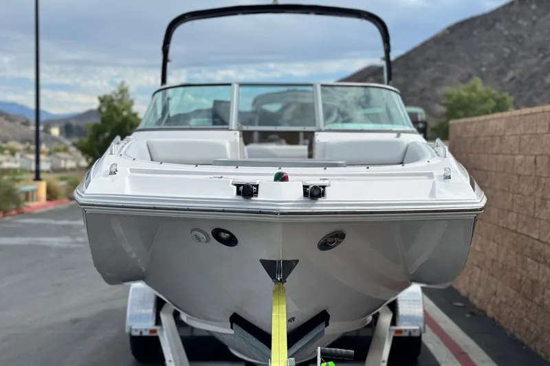 Slide: The Image of 2014 Regal 27 FasDeck boat on trailer, parked outdoors with scenic background. - 2