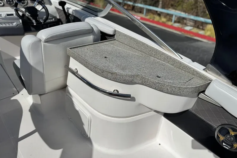 Slide: The Image of 2014 Regal 27 FasDeck boat interior with granite countertop and white seating. - 23